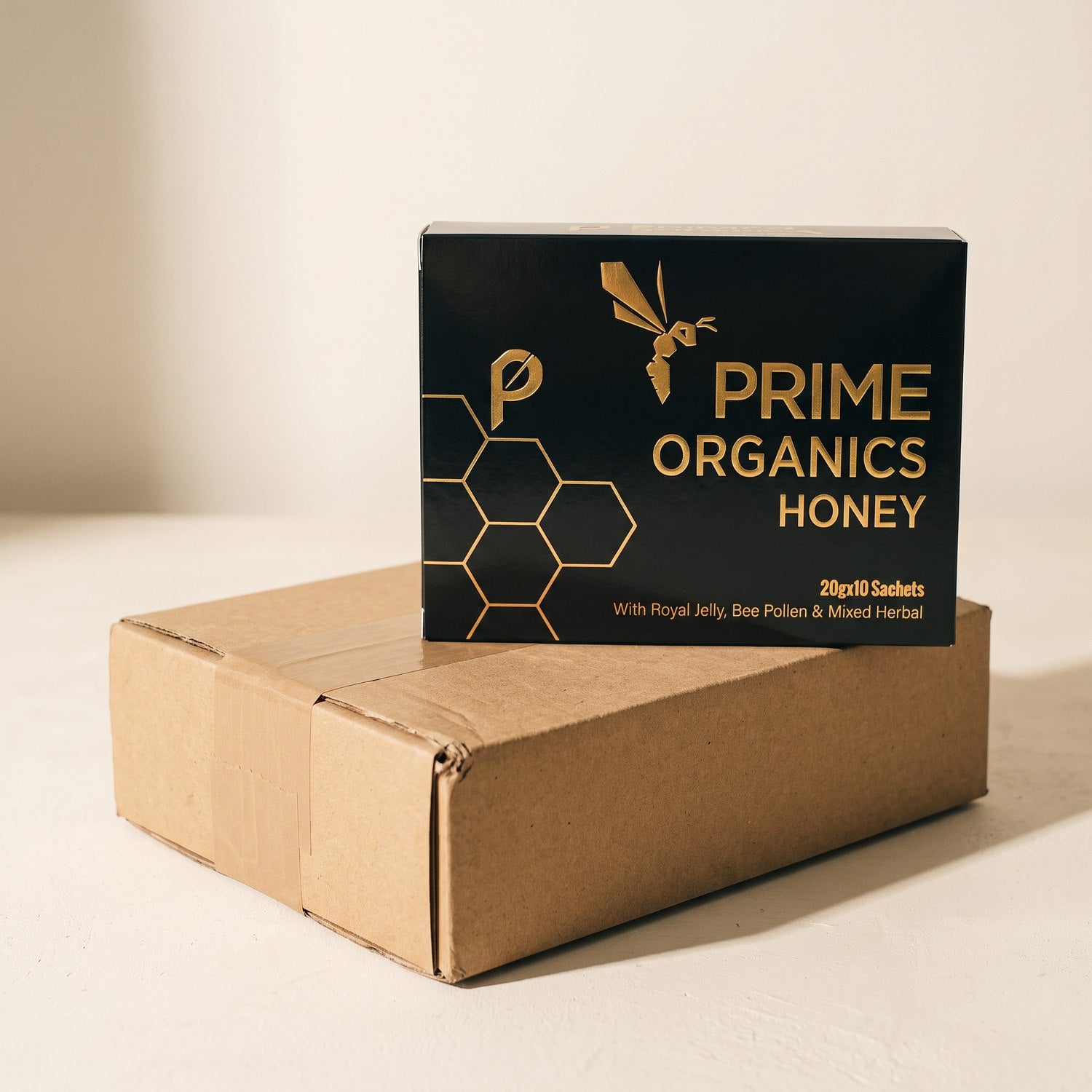 A plain unbranded kraft shipping box with the Prime Organics Honey box resting on top of it