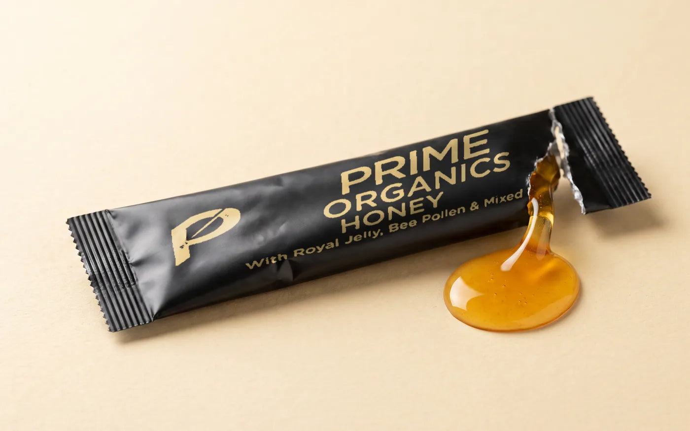 A Prime Organics Honey sachet torn open, honey already flowing out of it